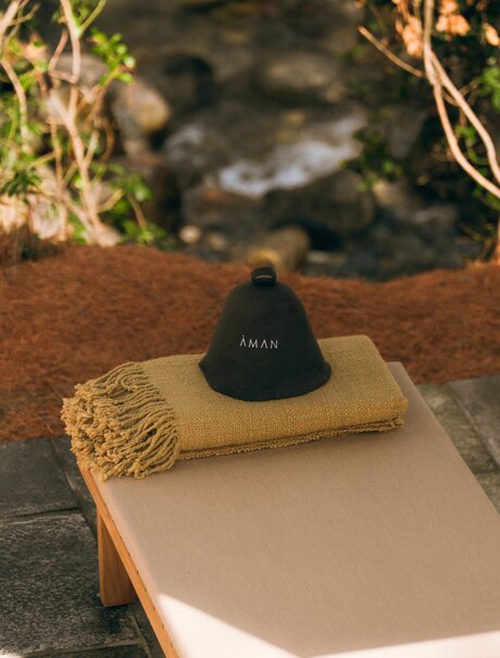 Banya sauna session setup at Amankora's Paro Lodge, with traditional heated stone on wooden base.
