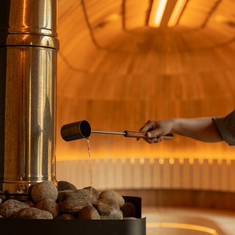 Traditional wood-fired sauna with steam rising at Amankora's Paro Lodge, Bhutan.