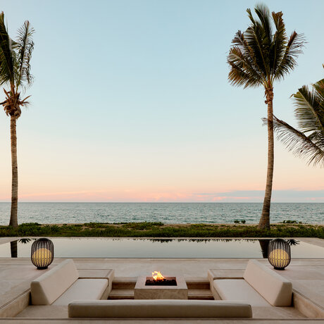 Beachfront casita at Amanvari with sunken seating area overlooking the ocean at dusk, Mexico.