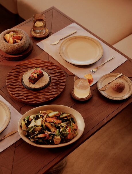 Amanvari beach club dining table with Mexican-inspired dishes and earthenware serving pieces.