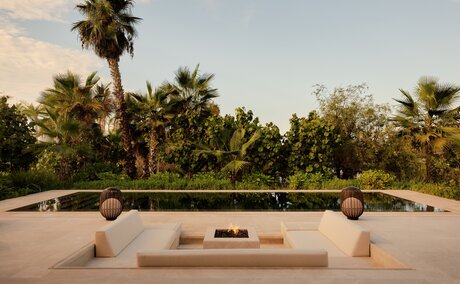 Estuary Casita at Amanvari with sunken seating area overlooking palms and mangrove estuary at dusk, Mexico.