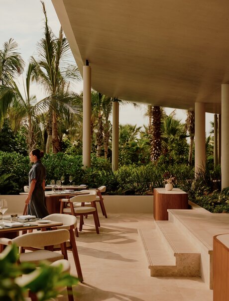 Covered terrace at Amanvari with dining furniture and views towards lush gardens in Mexico.