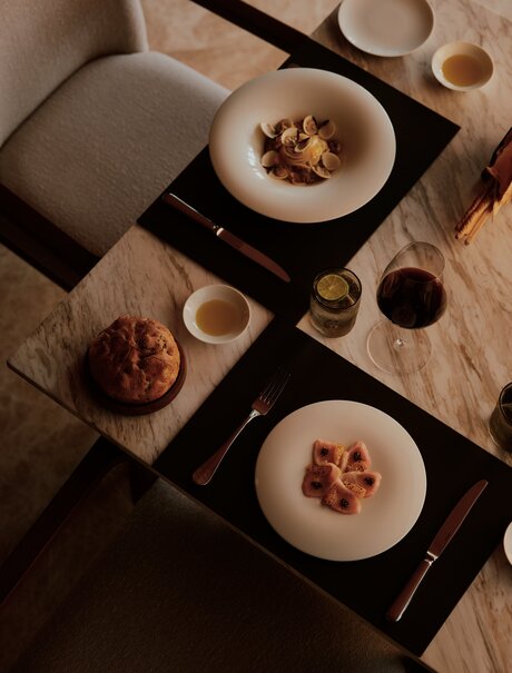Overhead view of plated dishes and beverages arranged on a table at Amanvari, Mexico.