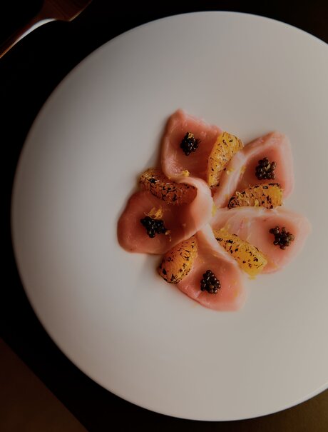 Plated dessert with red fruit coulis and gold leaf at Amanvari, Mexico.