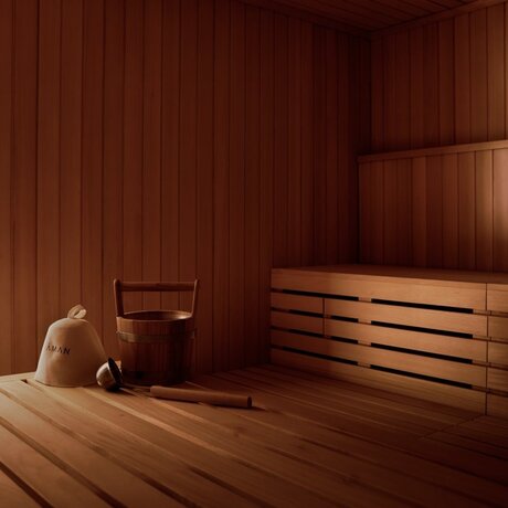 Wooden banya sauna at Amanvari with traditional bench seating and warm timber interior.