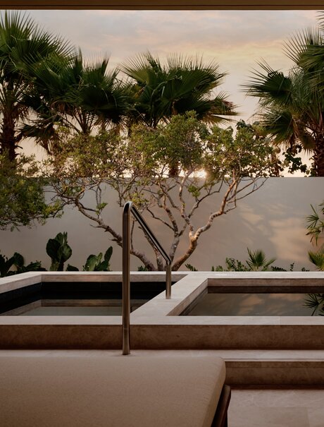 Spa hydrotherapy area at Amanvari with sculptural tree and shallow reflecting pool.