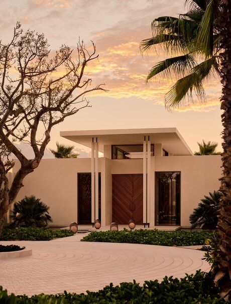 Spa entrance at Amanvari with sculptural pavilion at dusk, framed by desert palms.