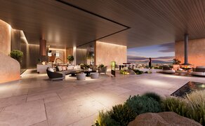 Amansamar interior lounge with warm lighting, contemporary seating, and expansive windows overlooking the landscape.