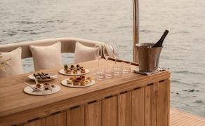 Wooden catamaran deck with canapés and refreshments served during a Vietnam experience at Amanoi.
