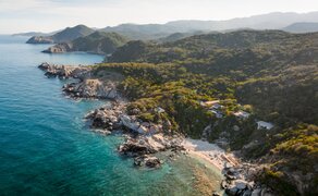 Aerial view of Amanoi's coastal residence overlooking turquoise waters and forested Vietnamese coastline.