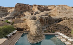 Main pool at Amangiri with desert rock formations and terracotta-hued cliffs.