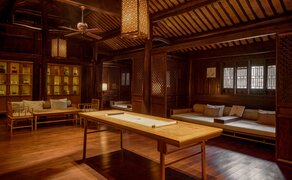 Amanfayun exhibition space with wooden interiors, traditional latticed windows and central display table.