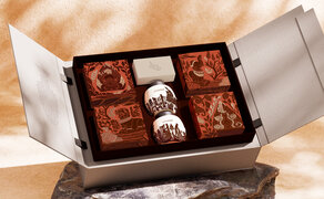 Amanoi resort mooncake box with assorted chocolates and traditional pastries, presented in elegant black packaging.