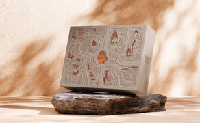 Amanoi mooncake box displayed on a dark stone dish, casting shadows in warm sunlight, at the resort.