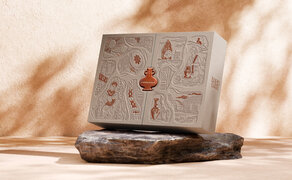Amanoi mooncake box with red seal detail, positioned on textured surface at the resort.