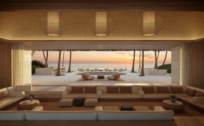 Amanolu living room with panoramic window overlooking coastal landscape at sunset.