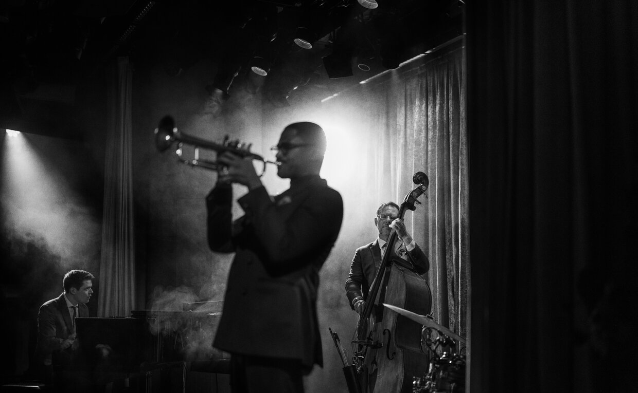 Musician performing at Aman New York, captured in black and white.