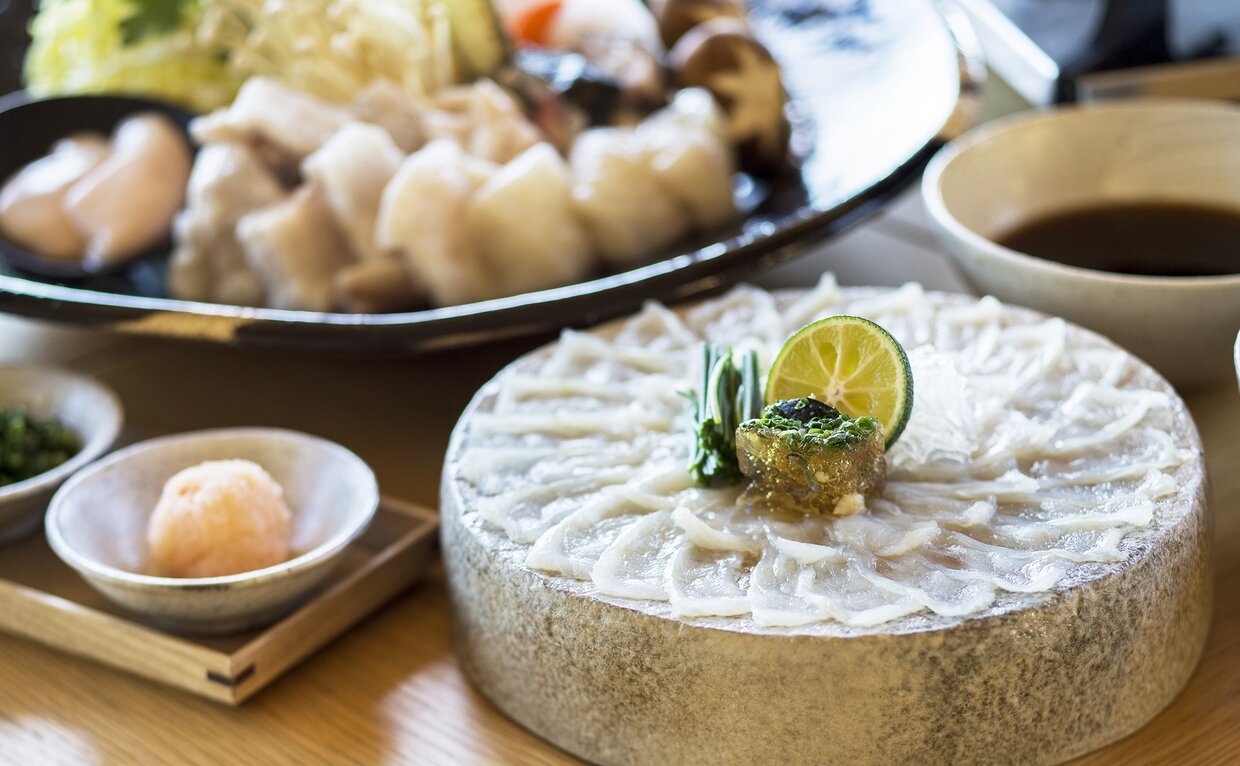 Fugu prepared at Amanemu, served with dipping sauce and steamed buns during winter.