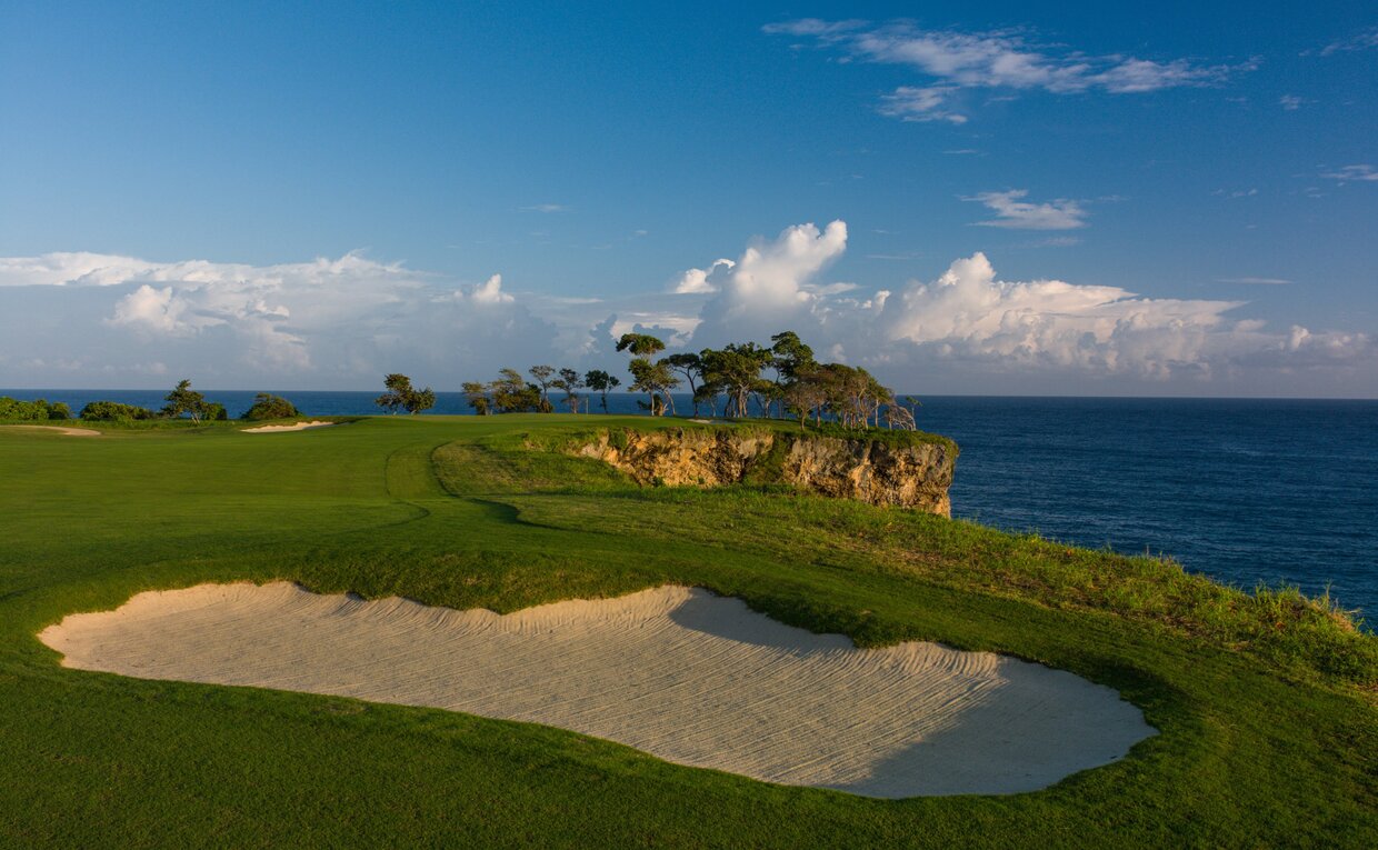 Golf course fairway at Amanera with coastal views and sandy bunker overlooking the sea.