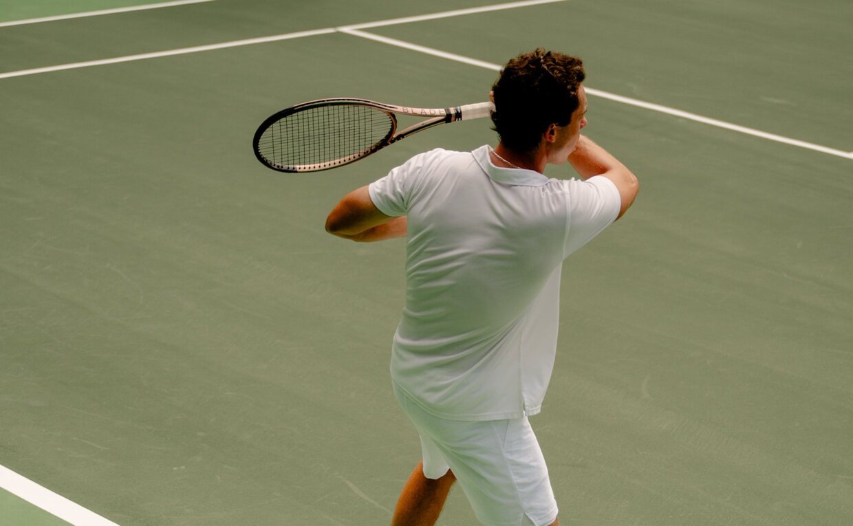 Model playing tennis on Amanera's court in Thailand.