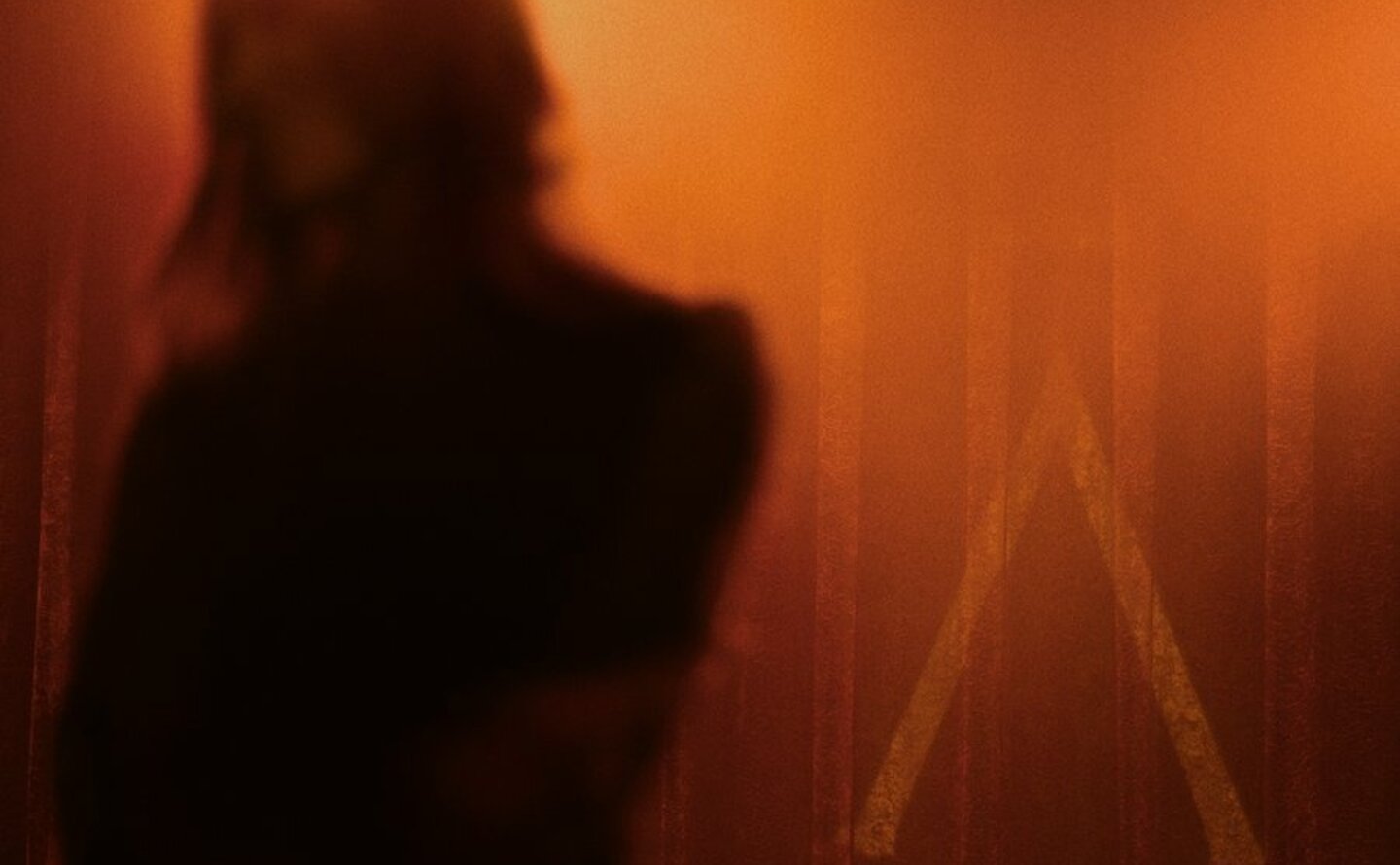 Silhouetted figure at The Jazz Club, Aman New York, during a band and DJ performance.