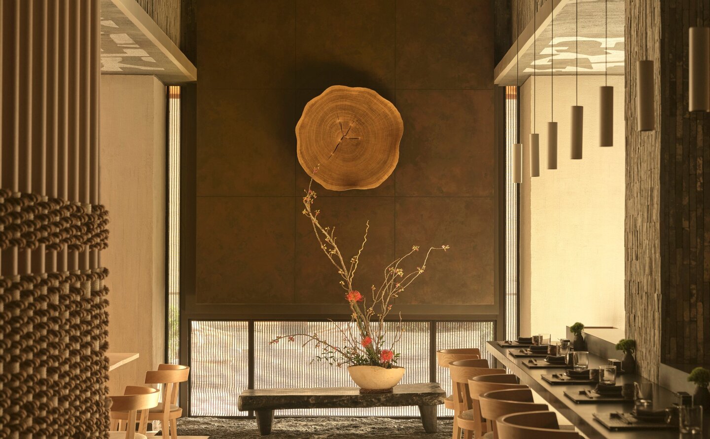 Spa bathroom at Aman New York with marble vanity, round mirror, and classical columns.