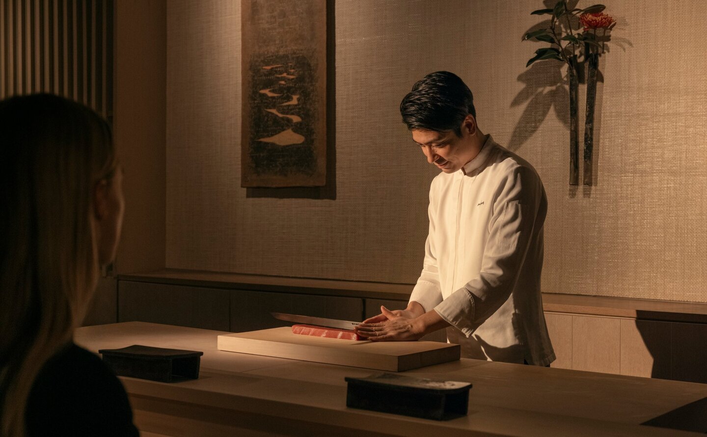 Woman viewing artwork in gallery at Aman New York, USA.