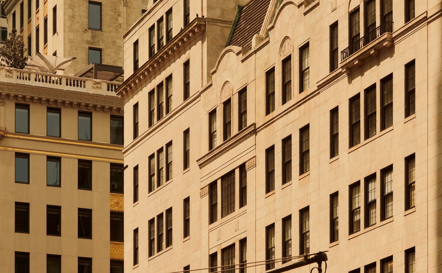 Neoclassical buildings in Manhattan with warm stone facades, Aman New York.