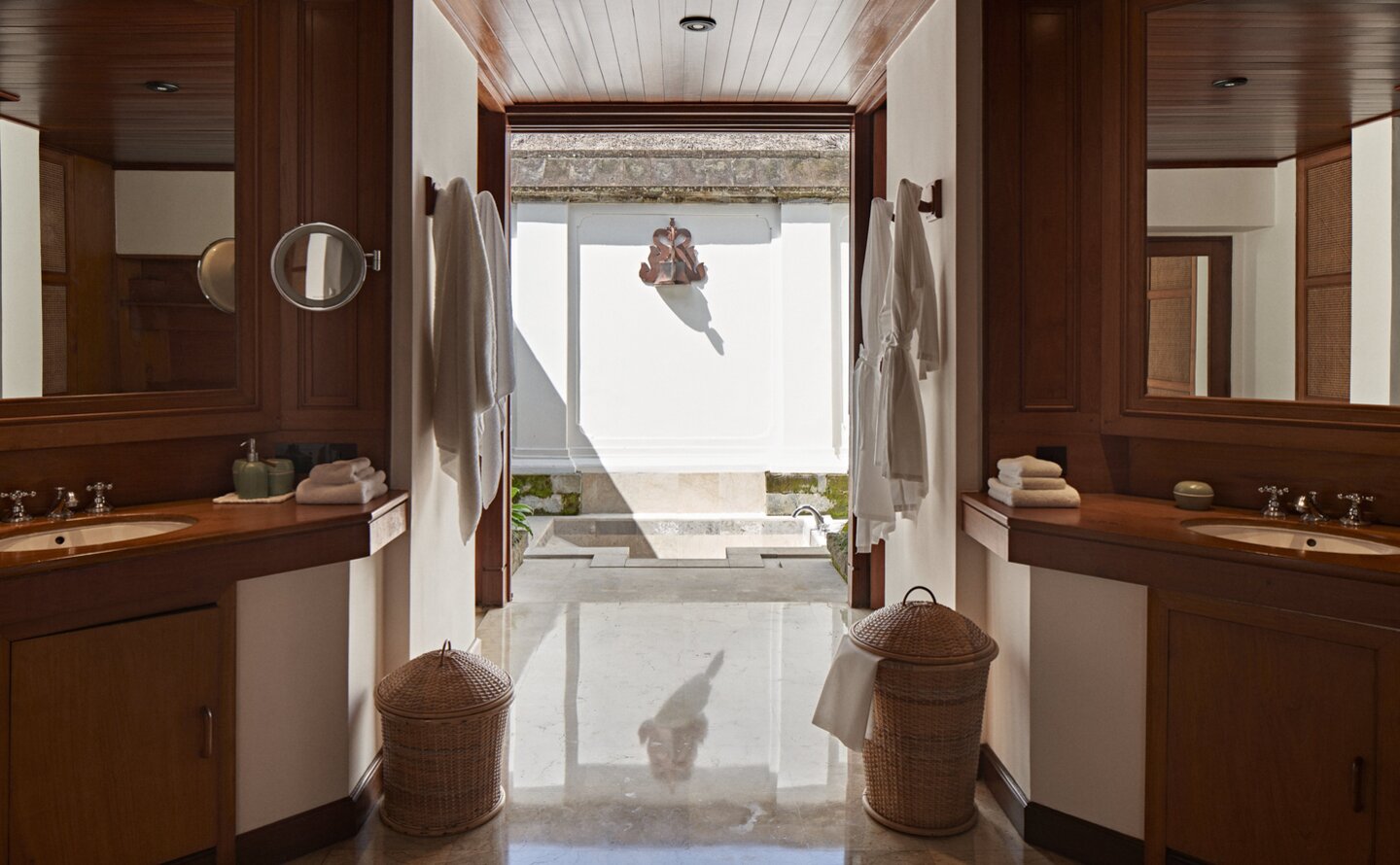 Duplex Pavilion bathroom at Amandari with dual vanities, marble flooring and view to garden.