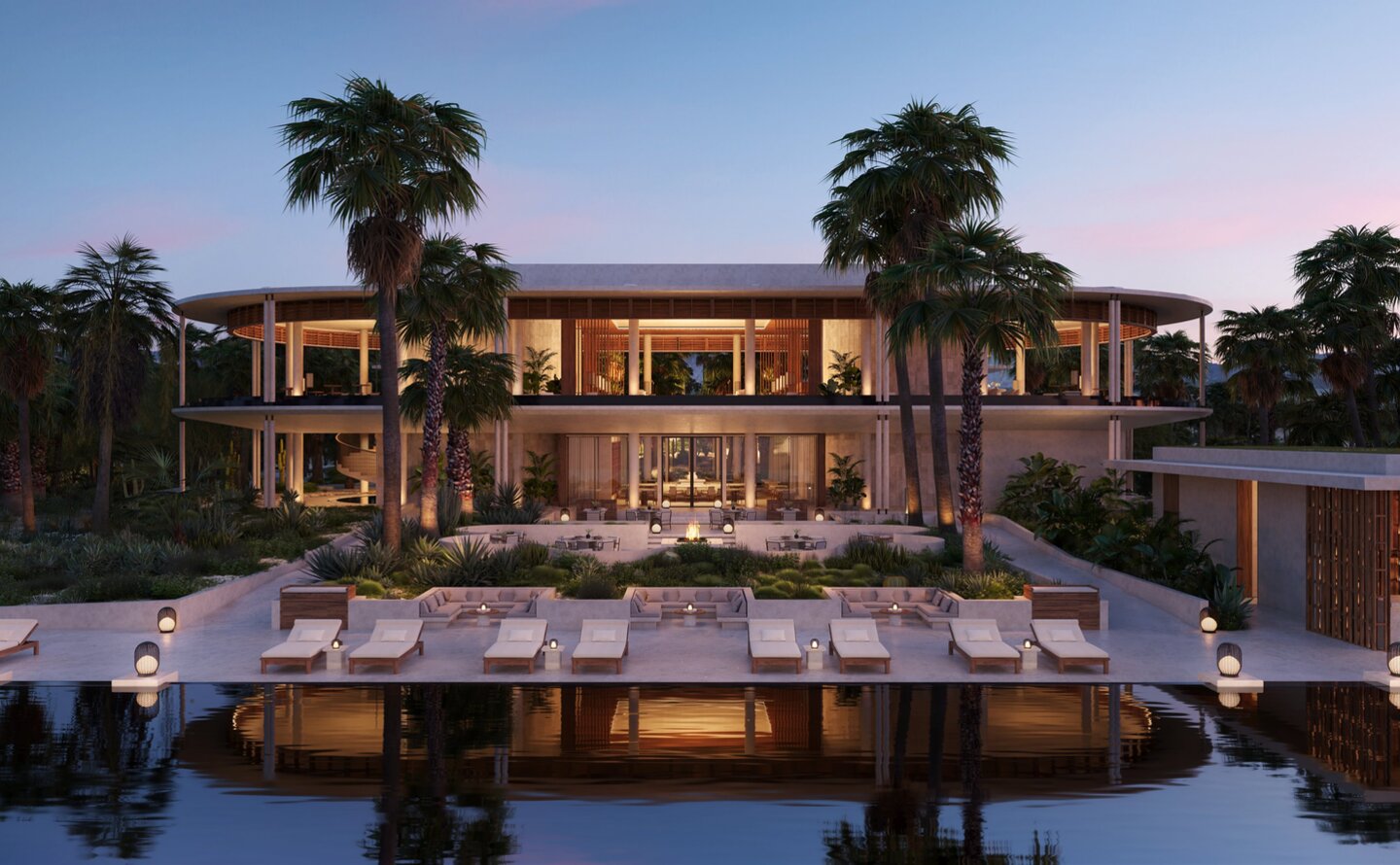 Casa Grande Lodge at Amanvari, Mexico, illuminated at dusk with dining pavilion reflected in still water.