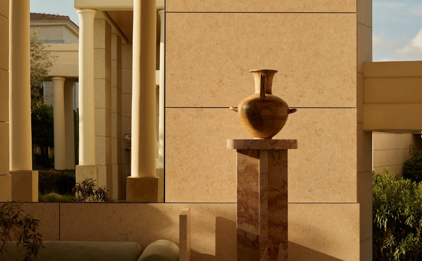 Amanzoe resort interior with stone sculpture and warm architectural lighting.
