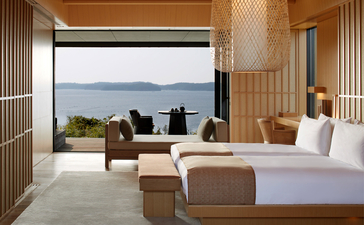 Principal bedroom at Amanemu with panoramic coastal views and minimalist décor.