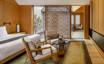 Principal bedroom at Amanyangyun with wooden furnishings and contemporary design overlooking gardens.
