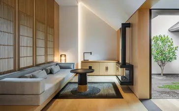 Principal bedroom at Amanyangyun with platform bed, shoji screens, and garden views.