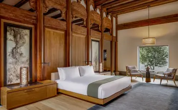 Principal bedroom at Amanyangyun with wooden architectural details and garden views.