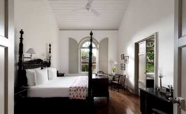 Principal bedroom at Amangalla with four-poster bed and colonial architecture.