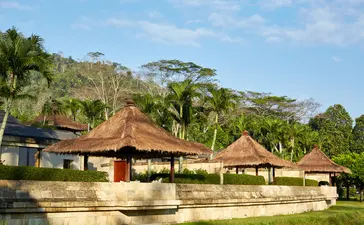 Amanjiwo's Borobudur Suite with thatched-roof pavilions set amongst tropical gardens in Indonesia.
