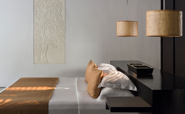 Contemporary Suite at Amansara with wooden pendant lights and geometric floor detail in Cambodia.