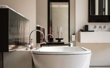 Contemporary Suite bathroom at Amansara with freestanding oval bathtub and minimalist fixtures.