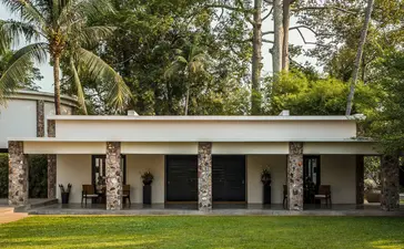 Courtyard Suite pavilion at Amansara with colonnade and manicured lawn, Cambodia.