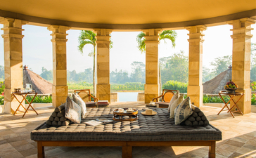 Dalem Jiwo Suite at Amanjiwo with views across Javanese landscape from columned pavilion.