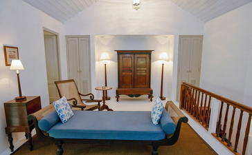 Principal bedroom at Amangalla with wooden bed frame and colonial furnishings.