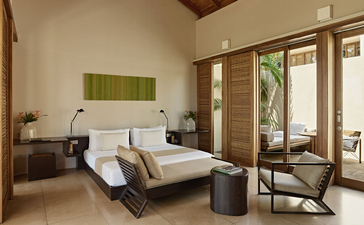 Garden Pool Suite principal bedroom at Amanwella, Sri Lanka, with bed and garden views.