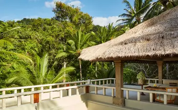 Garden Suite terrace at Amankila with thatched pavilion and tropical landscape views, Bali.