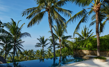Kilasari Suite pool overlooking palm-lined gardens at Amankila resort, Bali.