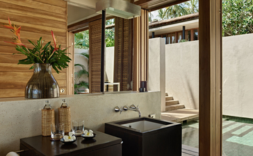 Ocean Pool Suite dining area at Amanwella, Sri Lanka, with wooden screens and garden views.