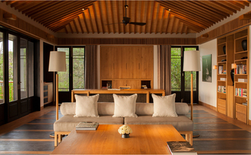Amanoi resort five-bedroom residence dining space with wooden ceiling, floor-to-ceiling windows and natural light.