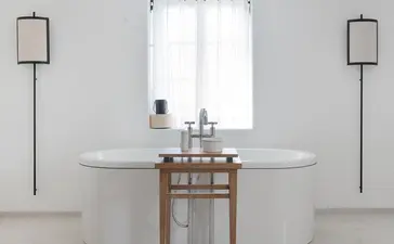 Principal bedroom ensuite with circular marble sink and wooden vanity at Aman Sveti Stefan.