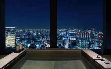Soaking tub overlooking Tokyo's illuminated cityscape at night, Aman Tokyo.