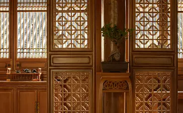 Carved wooden doors with geometric lattice panels at Amandayan.